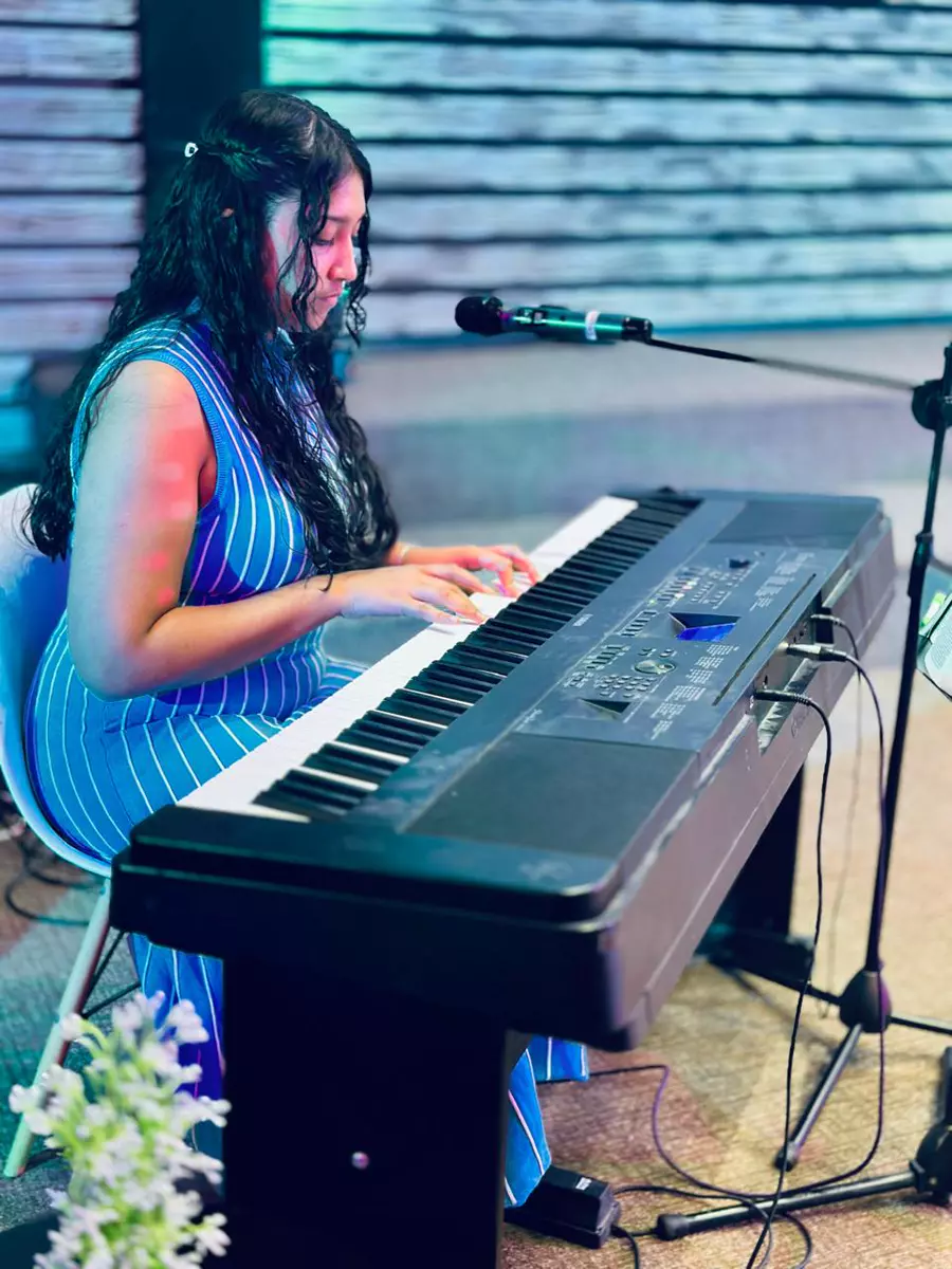 A young woman playing an electronic keyboard