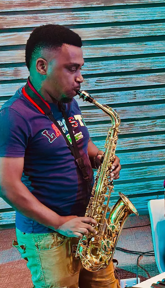 A man playing a gold saxophone